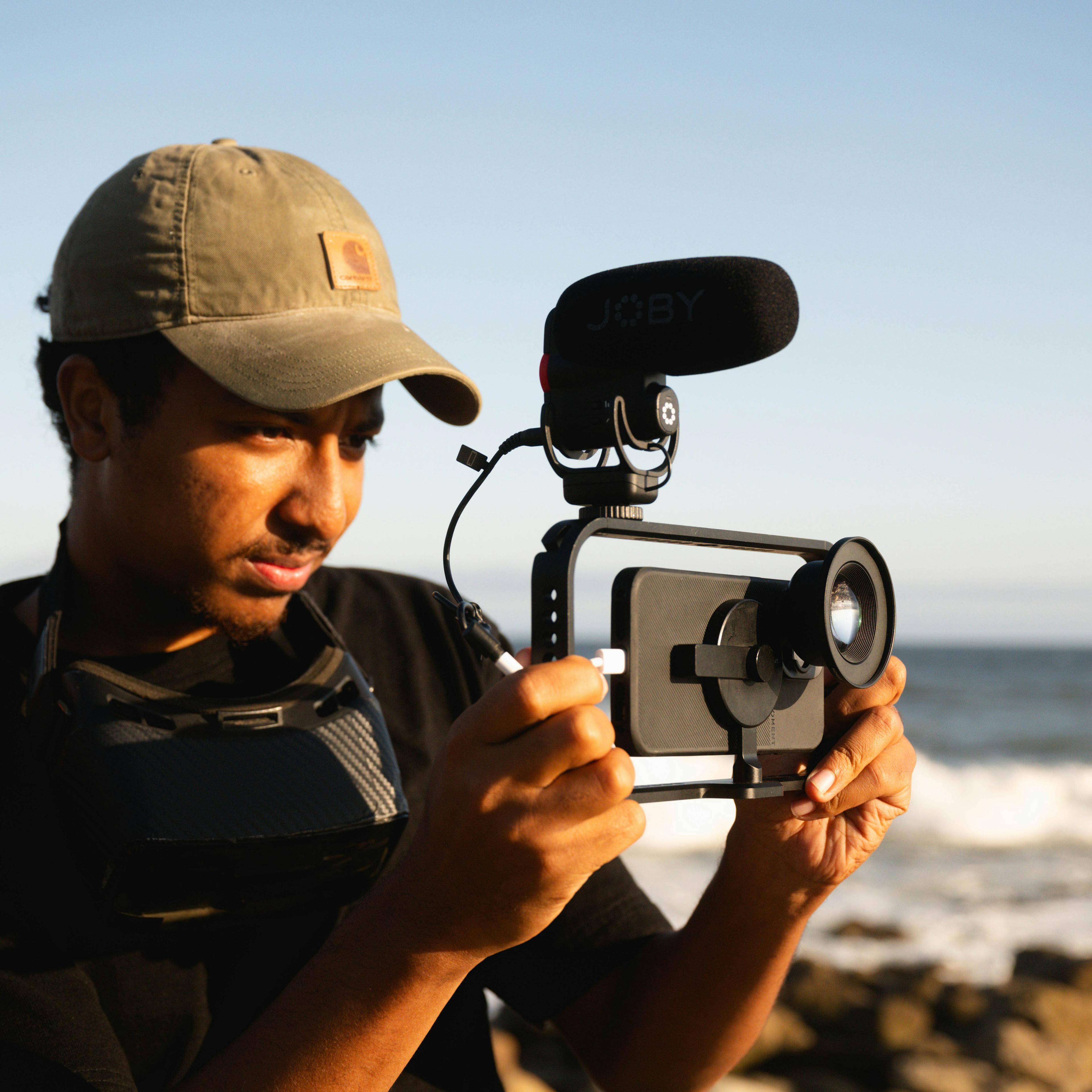 Man shooting a mobile rig with microphone on the beach